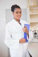 Smiling scientist looking at camera and holding file