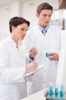 Scientists looking attentively at computer