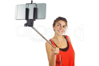 Casual brunette using selfie stick