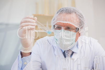 Scientist examining tube