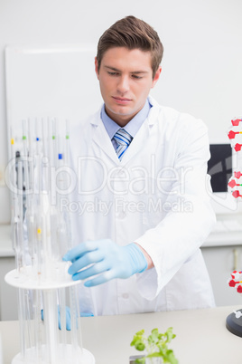 Scientist examining pipette
