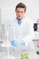 Scientist examining pipette