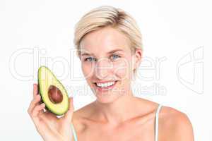 Pretty blonde holding half of an avocado