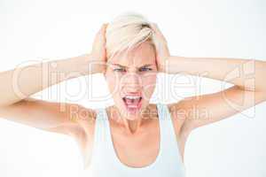 Angry woman screaming and holding her head