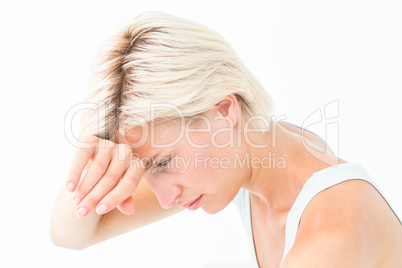 Sad woman crying with hand on forehead