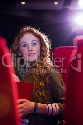 Young woman watching a film