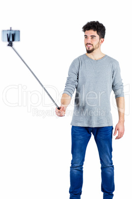 Casual man using a selfie stick