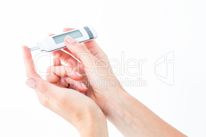 Woman testing her blood glucose level