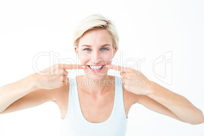 Happy blonde smiling showing her tooth