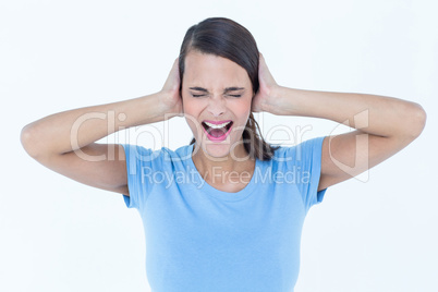 Screaming woman covering her ears