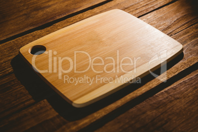 Chopping board on wooden table