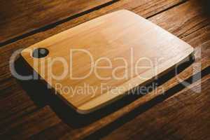 Chopping board on wooden table