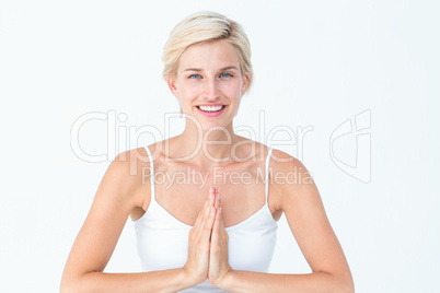 Happy woman doing yoga smiling at camera