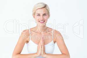 Happy woman doing yoga smiling at camera