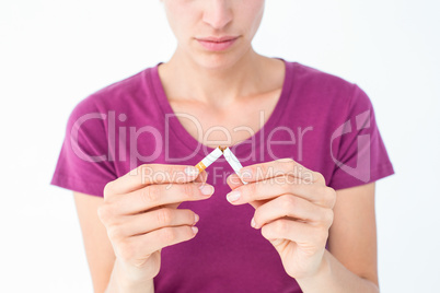 Pretty woman breaking a cigarette