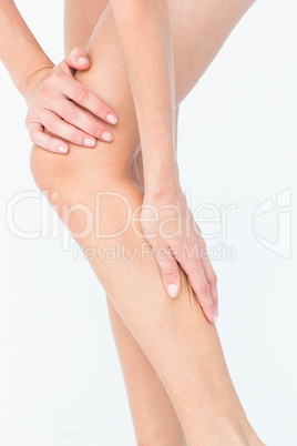 Attractive woman touching her leg