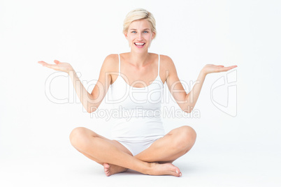 Happy blonde woman presenting something