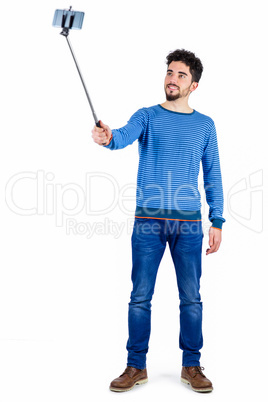 Casual man using a selfie stick