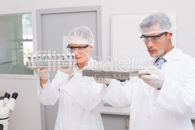 Scientists examining tubes