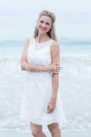 Smiling blonde in white dress looking at camera