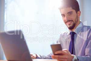 Businessman using laptop at desk