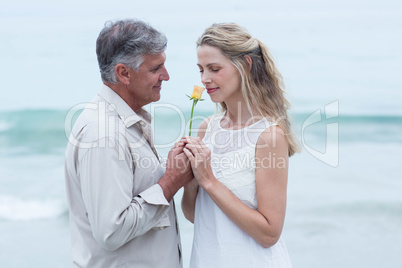 Happy man offering flower to his girlfriend