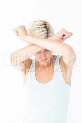 Upset woman holding her arms in front of her head