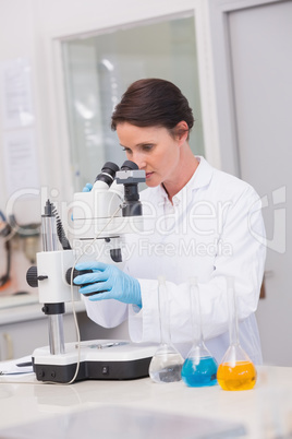 Scientist looking through a microscope