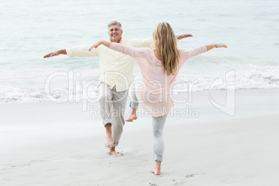 Happy couple doing yoga pose