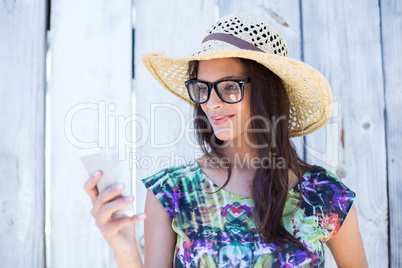 Smiling beautiful brunette using her phone
