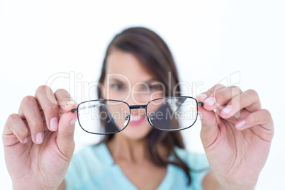 Pretty woman looking through her eyeglasses