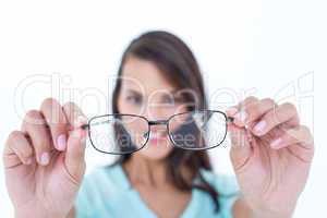 Pretty woman looking through her eyeglasses