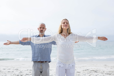 Happy couple doing yoga together