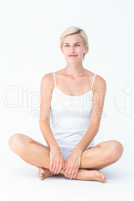 Smiling blonde woman sitting on the floor Smiling blonde woman sitting on the floor