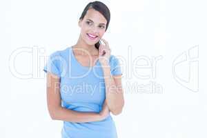 Thoughtful woman smiling with finger on cheek