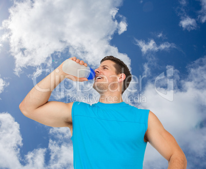 Composite image of smiling young man drinking water