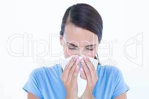 Sick woman blowing her nose