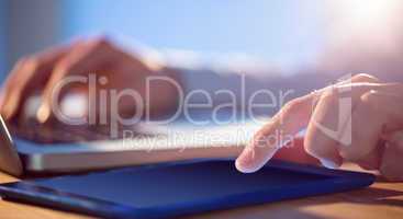 Businessman using laptop and tablet at desk