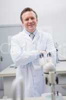 Happy scientist looking at camera with arms crossed