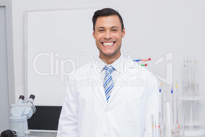 Happy scientist smiling at camera