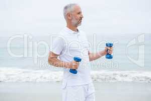 Fit man lifting dumbbells