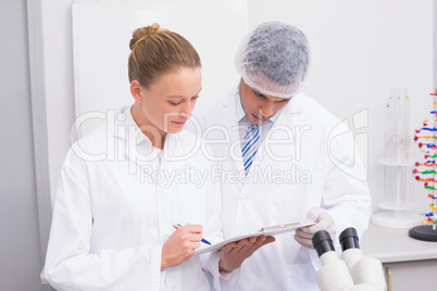 Focus scientist team looking at clipboard