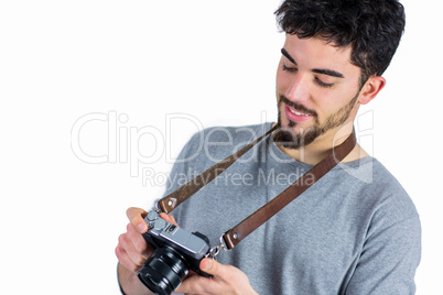 Casual man holding his camera