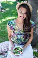 Smiling beautiful brunette having a picnic