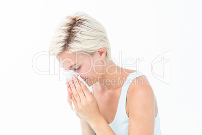 Sick woman blowing her nose