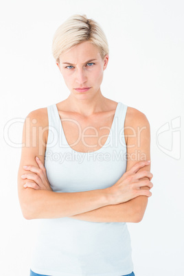 Upset blonde looking at camera with arms crossed