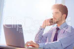 Businessman using laptop at desk