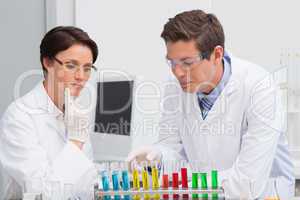 Scientists working attentively with test tube