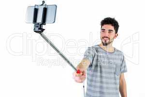 Casual man using a selfie stick