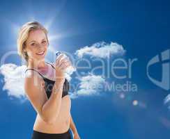 Composite image of fit blonde drinking water